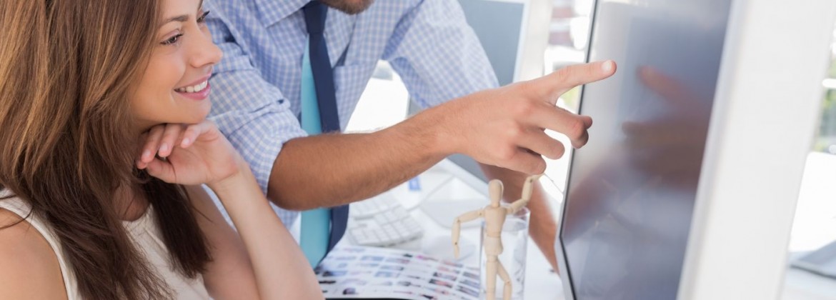 Man pointing something to his partner on screen in creative office